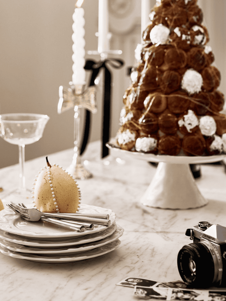 Elegant holiday dessert display with Christmas-themed decorations and pastries.