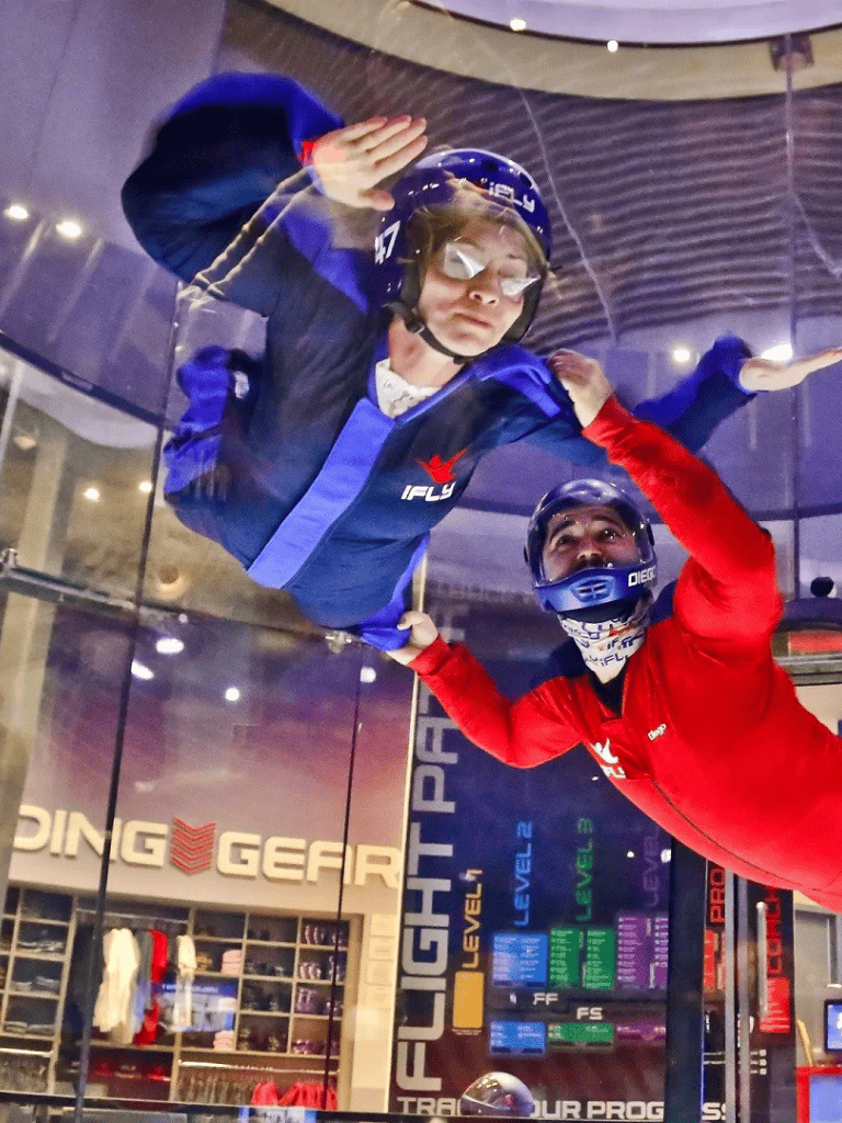 Exciting indoor skydiving experience at Quest For Directions, with professional instructors guiding the thrill.