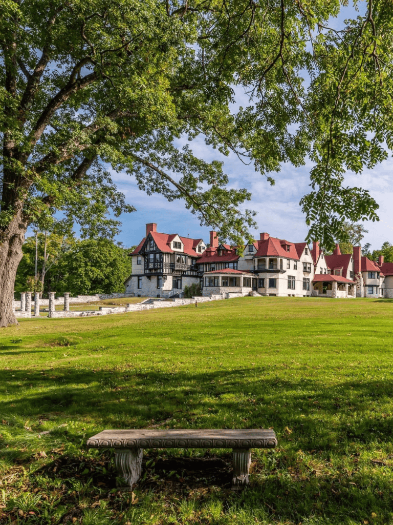 Elegant historic mansion surrounded by lush greenery and scenic park grounds, perfect for picturesque outings and special events.