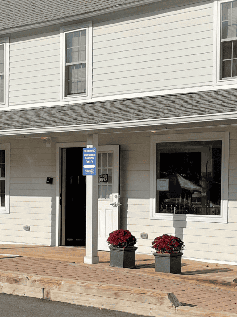 Reserved customer parking sign at a business entrance in a commercial area.