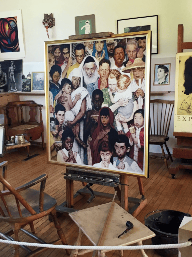 Diverse group portrait in art exhibition, highlighting cultural diversity and artistic expression.