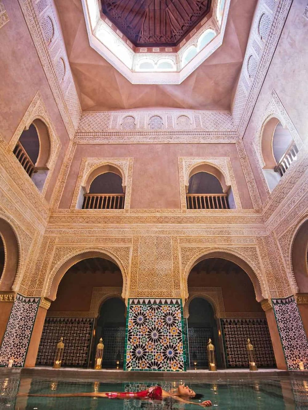 Luxurious Moroccan spa with intricate tilework and a tranquil indoor pool, perfect for relaxing and rejuvenating.