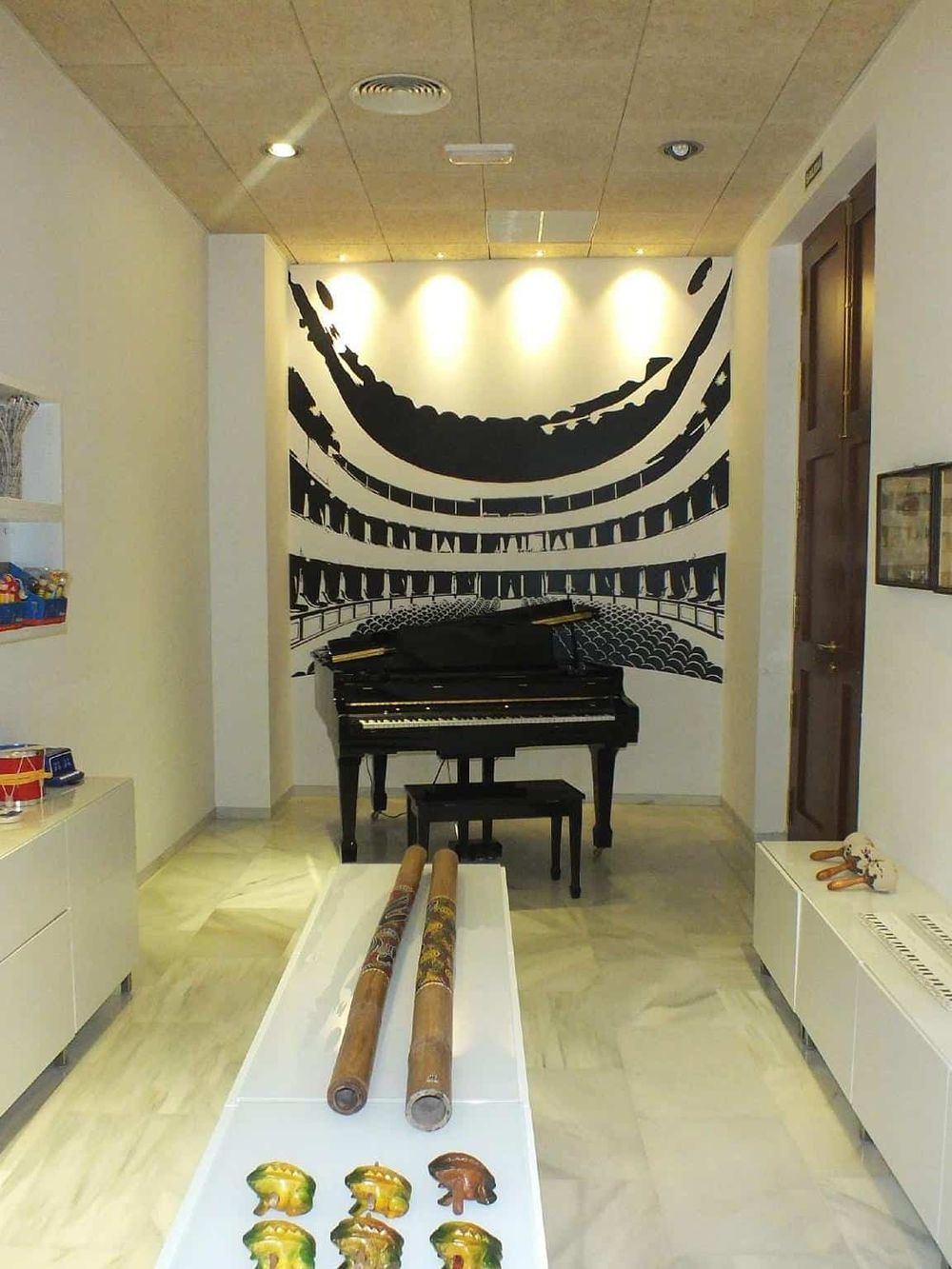 Colorful musical instruments and a grand piano create a lively, artistic atmosphere in this music-themed space.