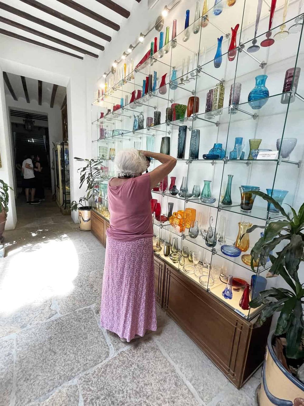 Colorful glass art display at QuestForDirections museum, showcasing unique handcrafted glass sculptures.