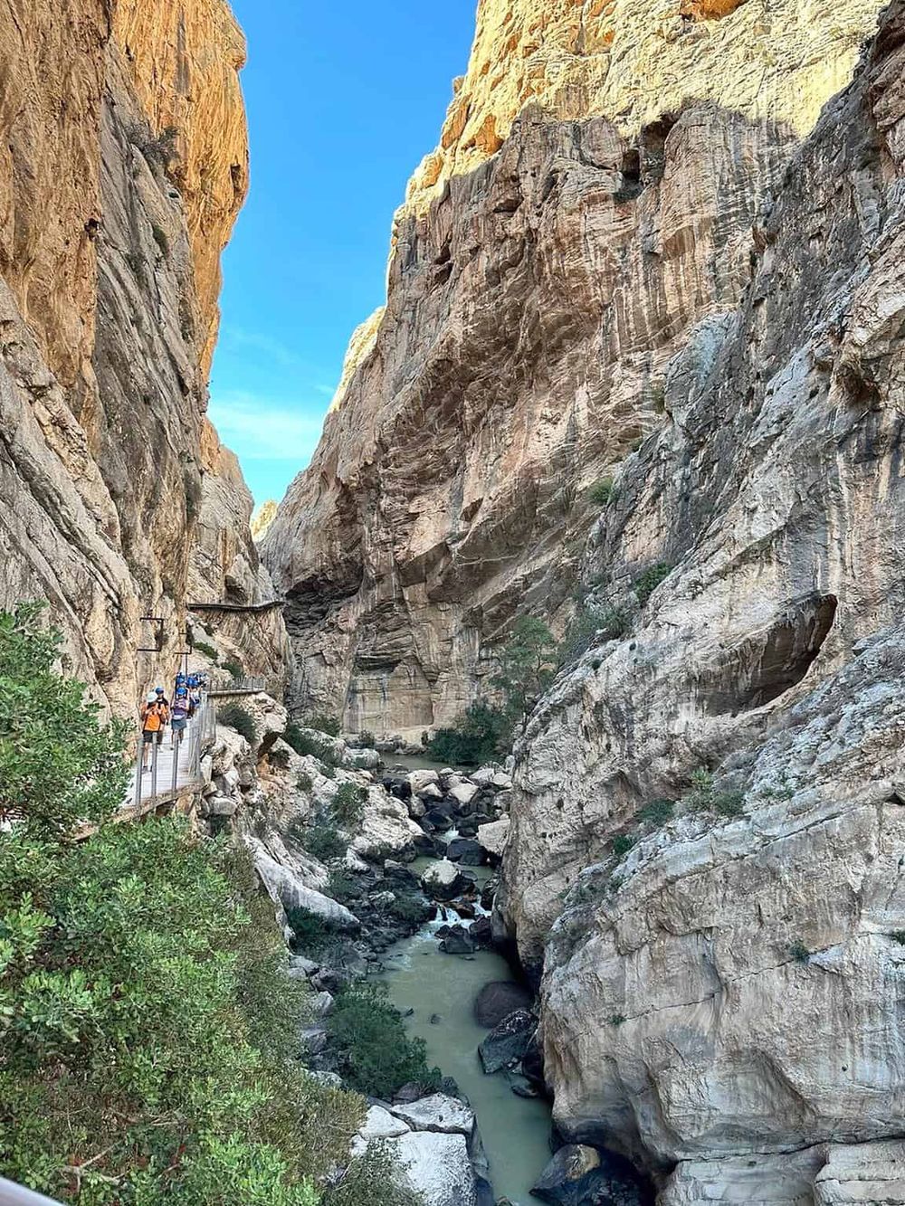 Breathtaking canyon with hiking trail, steep rock walls, and flowing river for outdoor adventure.