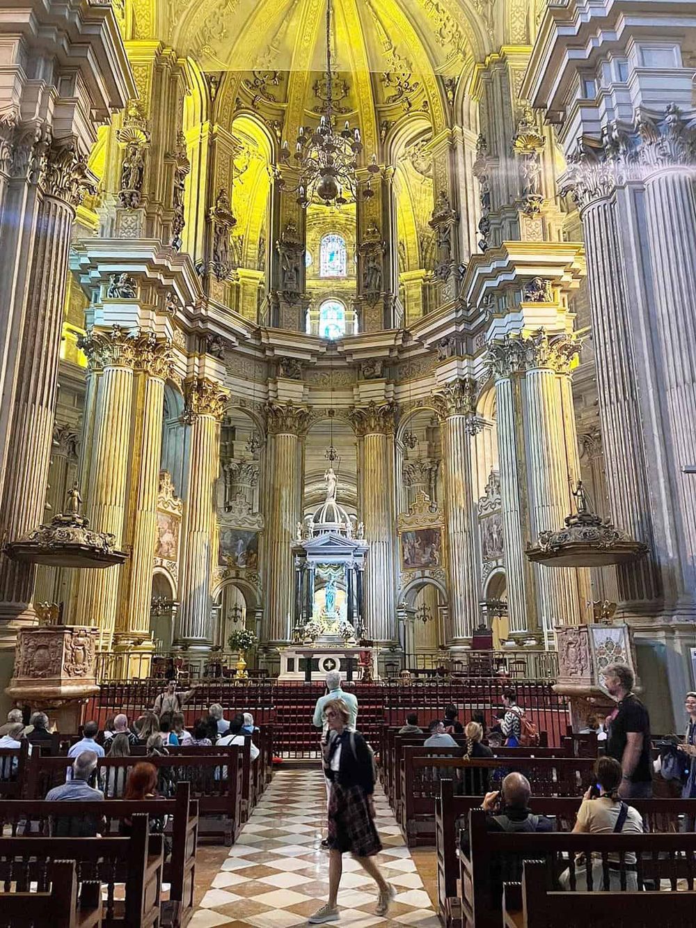 Stunning Baroque church interior with ornate gold details and impressive architecture.