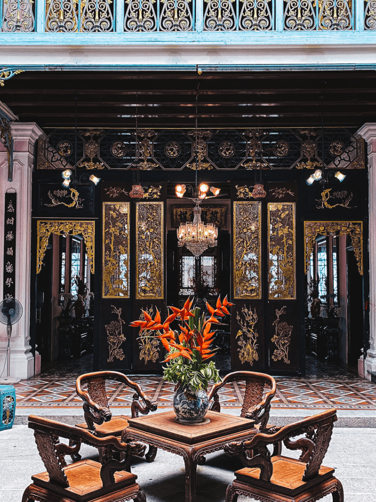 Elegant traditional Vietnamese interior with ornate wooden furnishings and floral decor, perfect for cultural exploration.