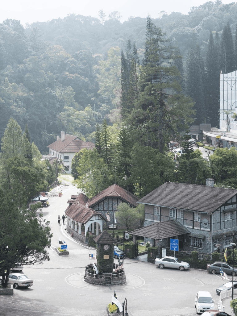 QuestForDirections scenic mountain village with historic buildings and lush forest surroundings.