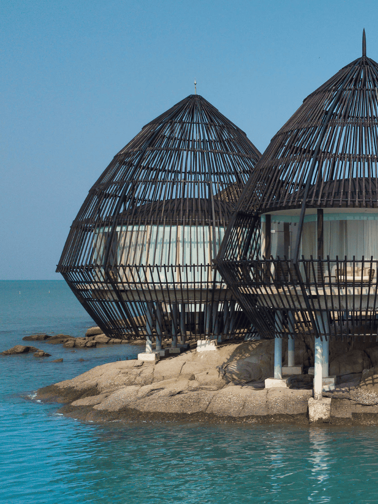 Seaside beach cabanas with modern wooden design for vacation relaxation.