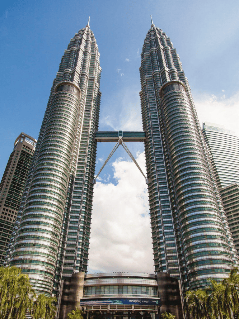 Luxurious modern skyscrapers in Kuala Lumpur with sky bridge connecting towers.