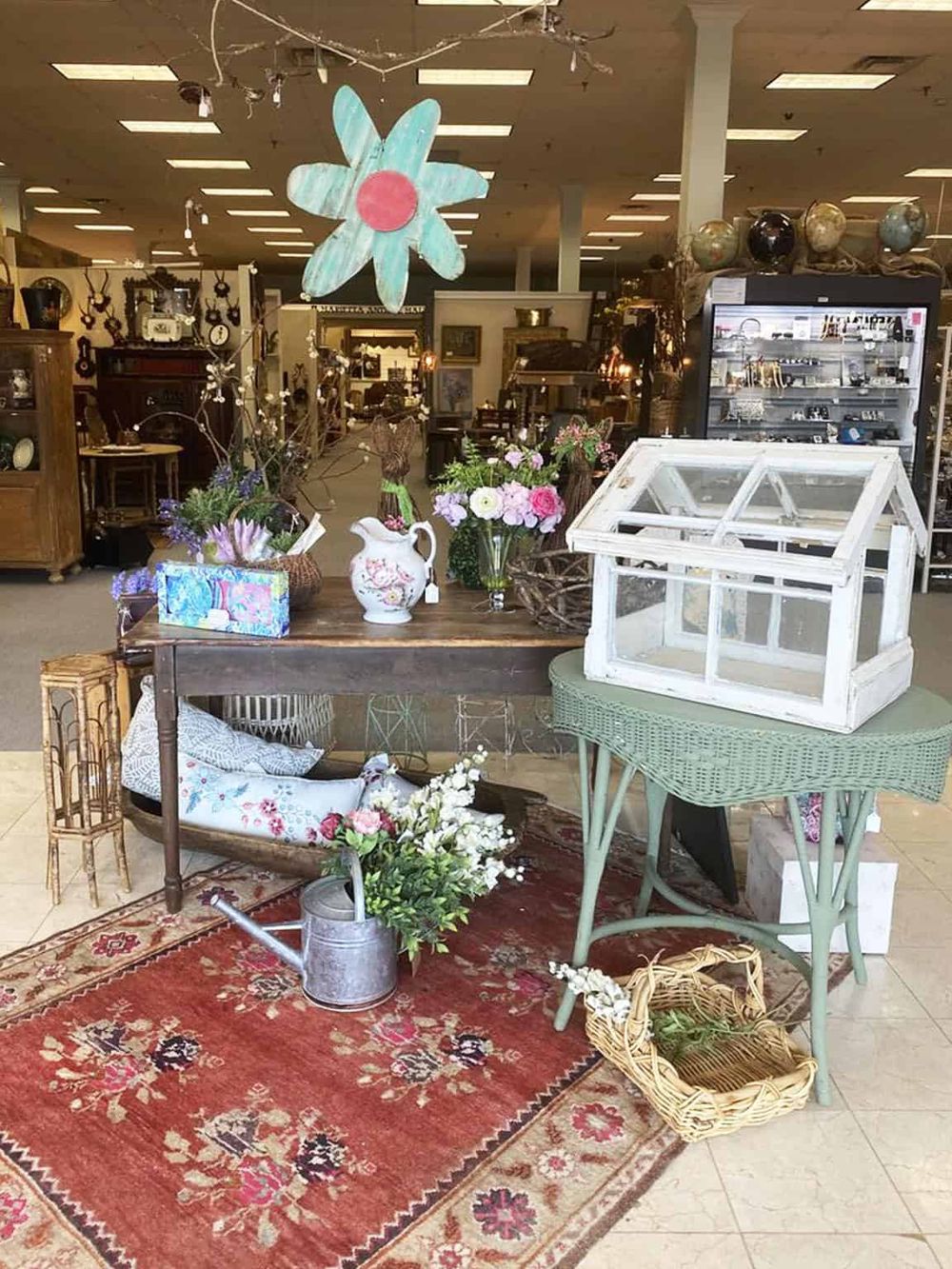 Colorful vintage home decor and floral arrangements in a boutique thrift store.