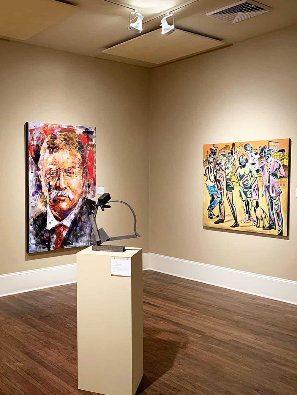 Colorful abstract portrait of a man with glasses in an art gallery.
