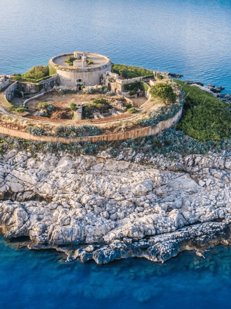 Aerial view of Fort on rocky coastline overlooking the ocean for travel and historical tours.