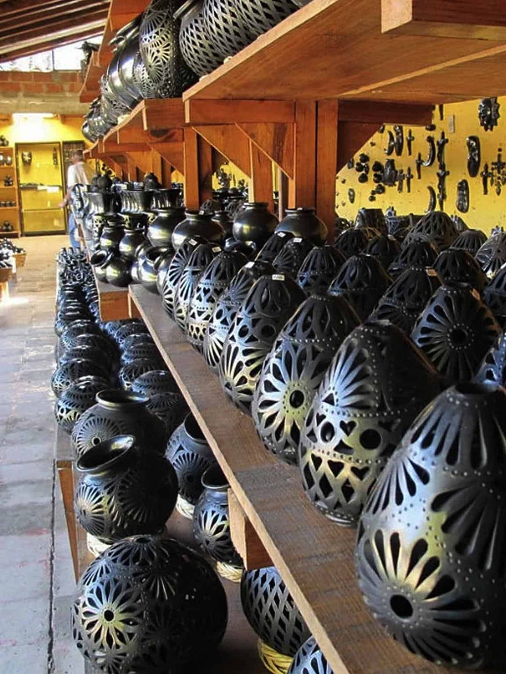Colorful handcrafted ceramic lanterns at a pottery shop for home decor and lighting.