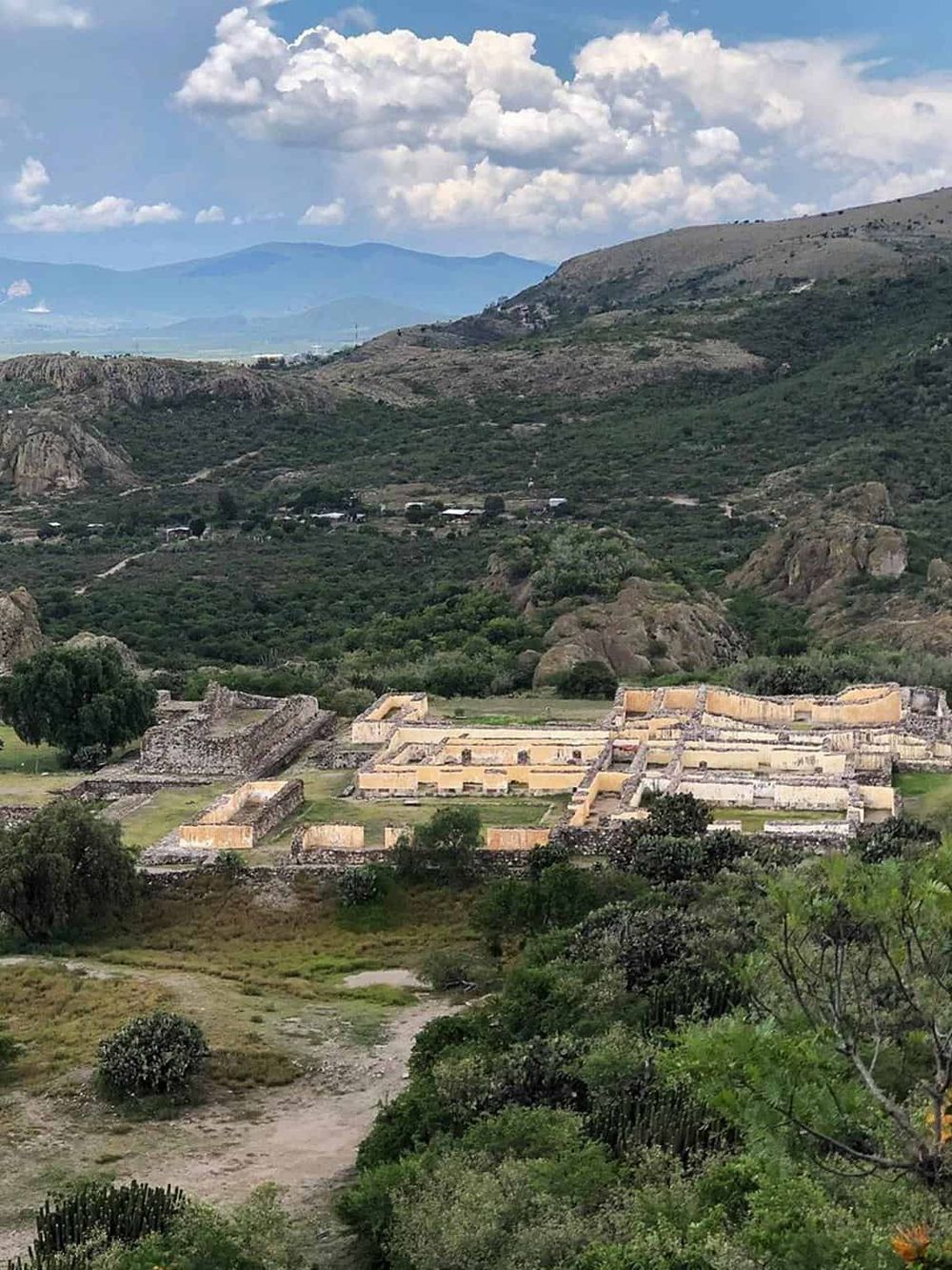 Ancient Mayan ruins surrounded by lush green mountains and scenic landscape, perfect for cultural exploration and guided tours.