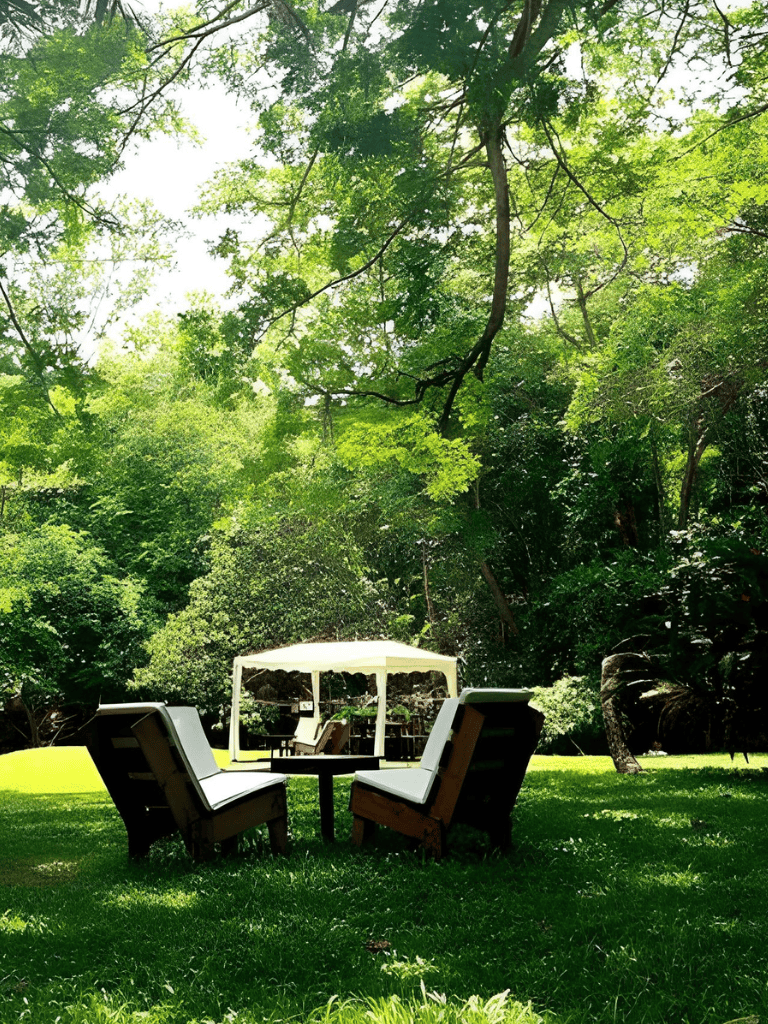 Spacious outdoor seating area with a gazebo and lush green trees, perfect for relaxation and social gatherings.