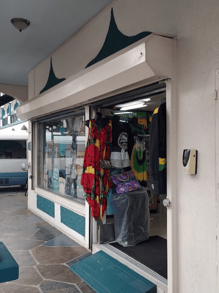 Colorful boutique clothing store with vibrant dresses and accessories on display.