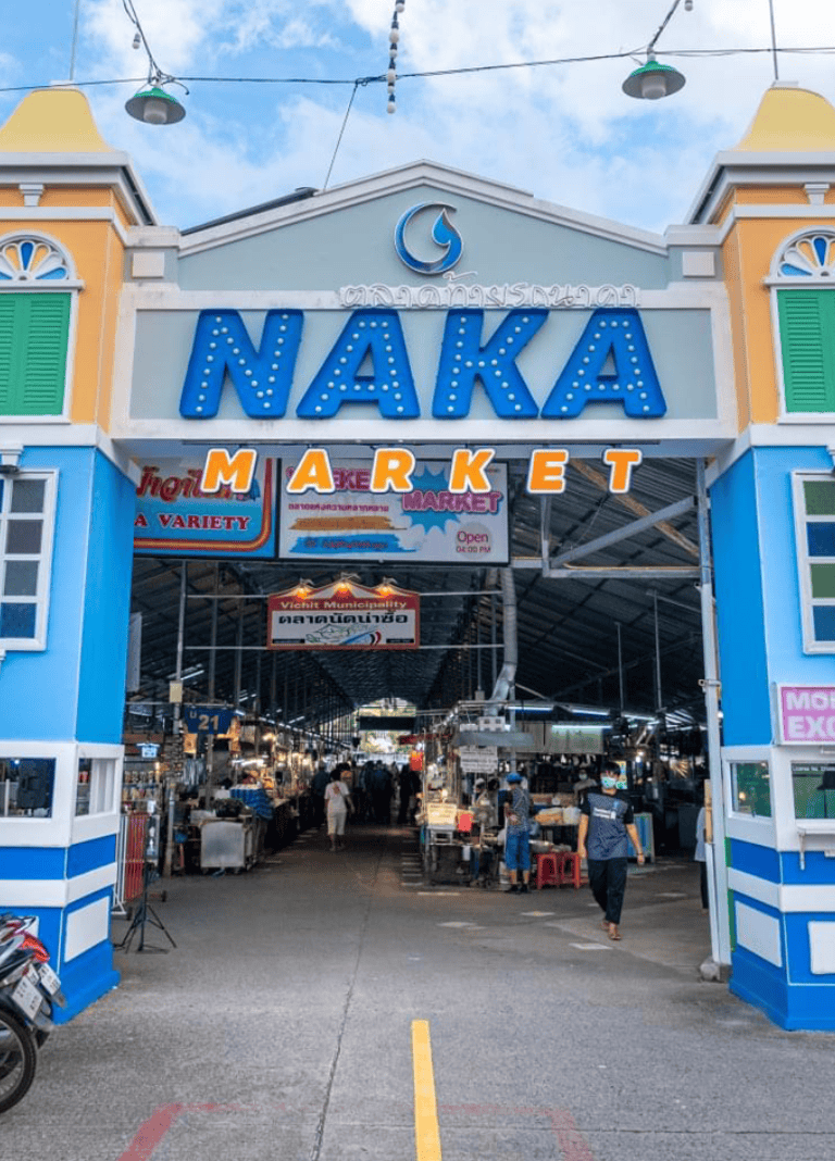 Colorful Naka Market entrance with vibrant signage and busy Asian street market scene.