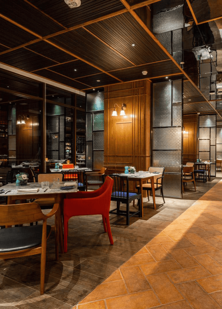 Cozy upscale restaurant interior with wooden accents and modern lighting, perfect for fine dining experience.