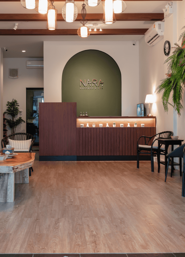 Warm modern massage spa reception with stylish wooden accents and ambient lighting.