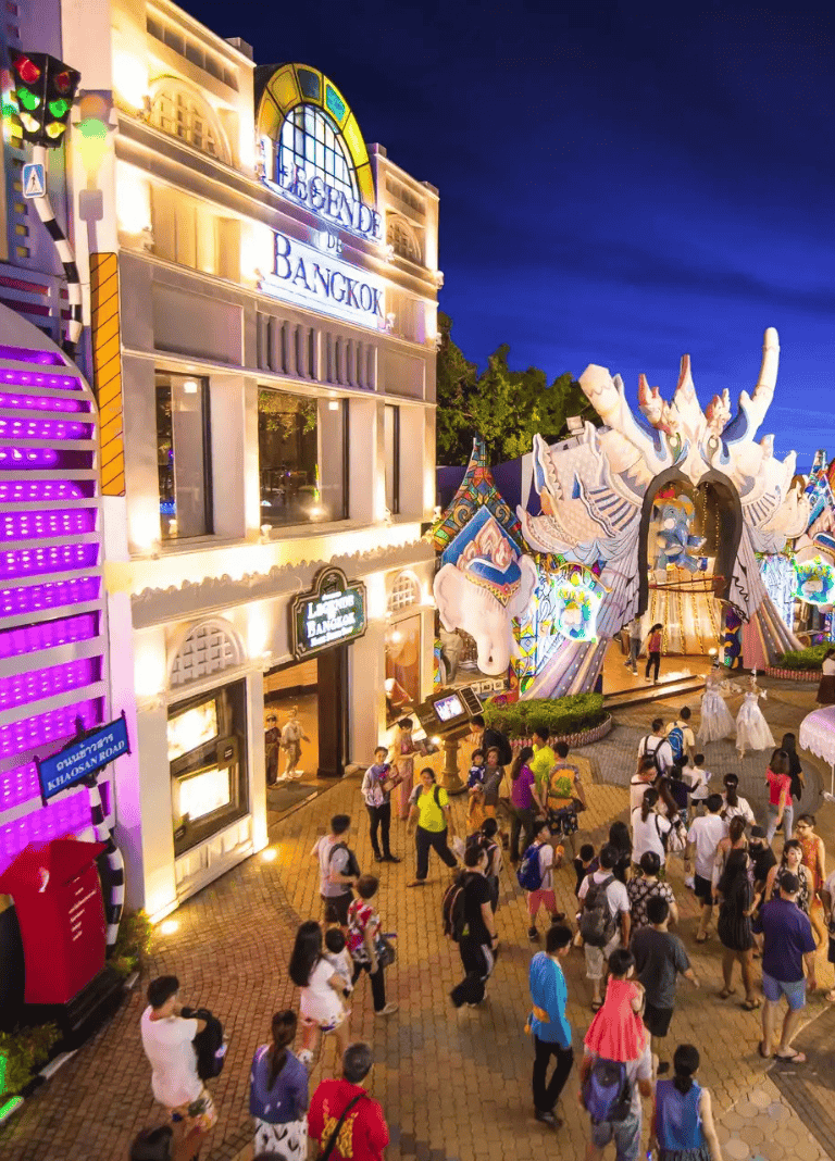 Brightly lit Quest for Directions at Asiatique Bangkok with nighttime festival atmosphere, colorful decorations, and crowds.