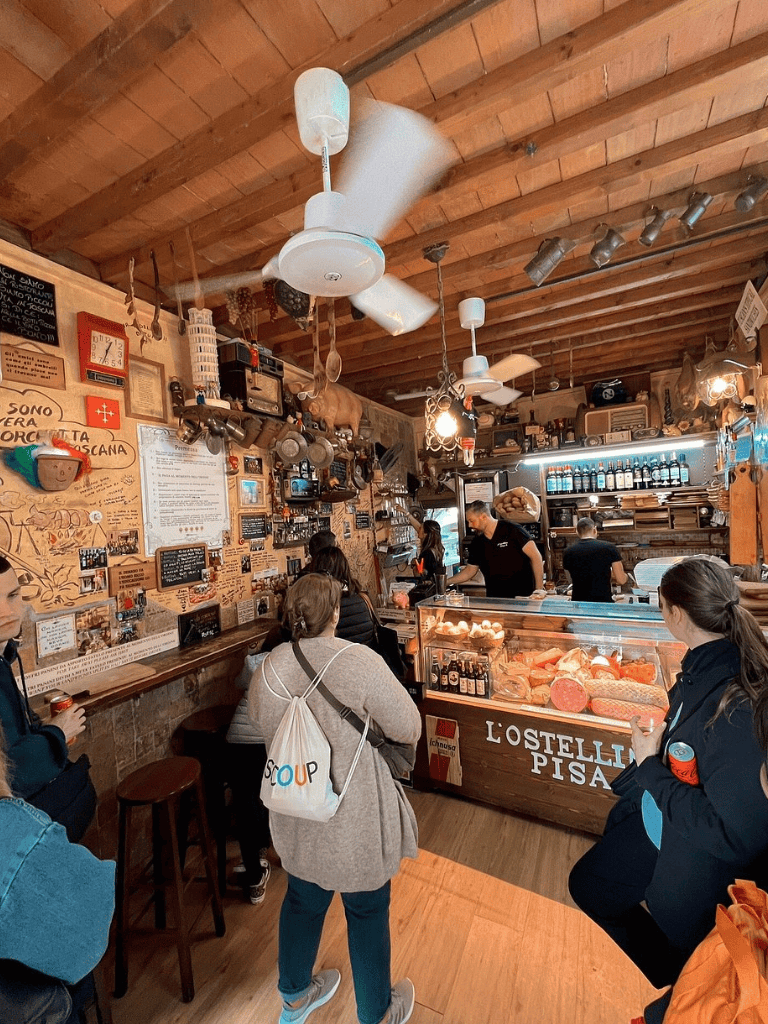 Traditional Italian deli and bakery with fresh cheeses, cured meats, and cozy rustic decor.