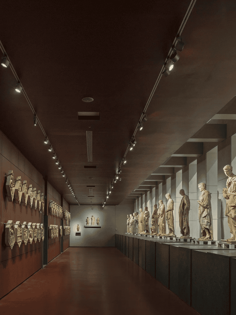 Ancient Roman sculptures and busts displayed in a museum exhibit for history and art enthusiasts.