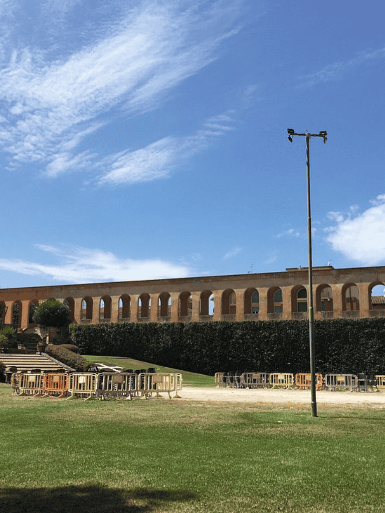 Empty outdoor event space with stage barriers under a blue sky at QuestForDirections site.