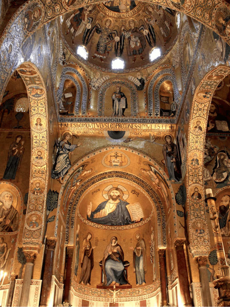 Intricate Christian church interior showcasing mosaics, religious icons, and sacred artwork.
