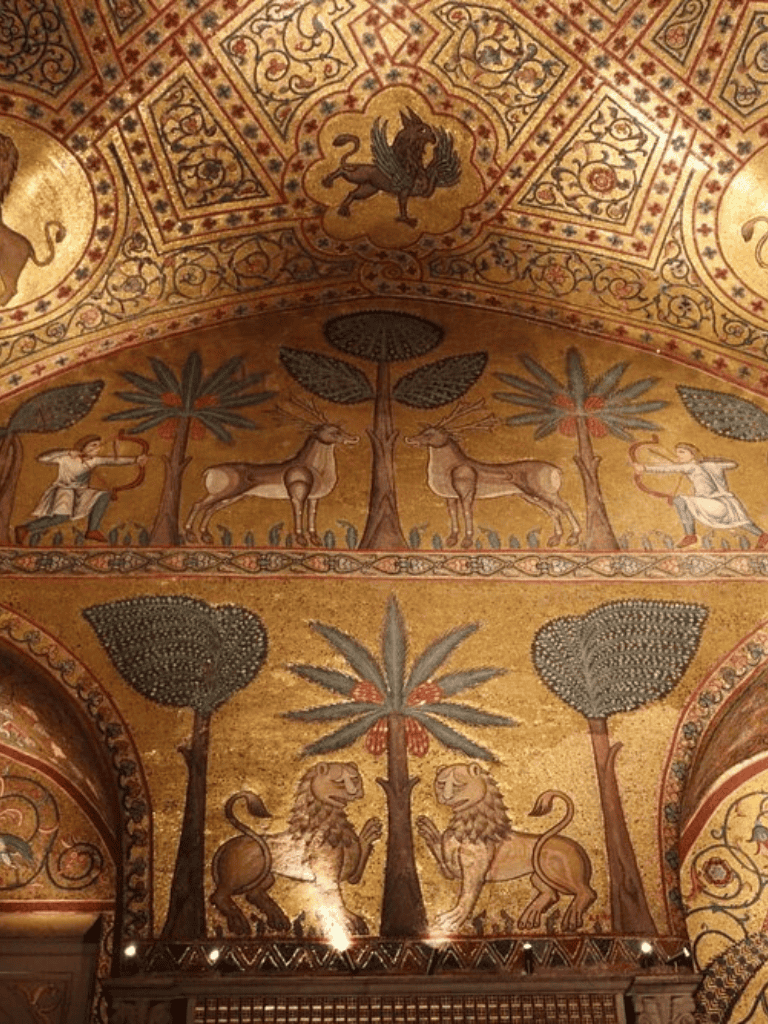 Ancient mosaic ceiling with lions, trees, and mythological creatures, showcasing historical art and architecture.