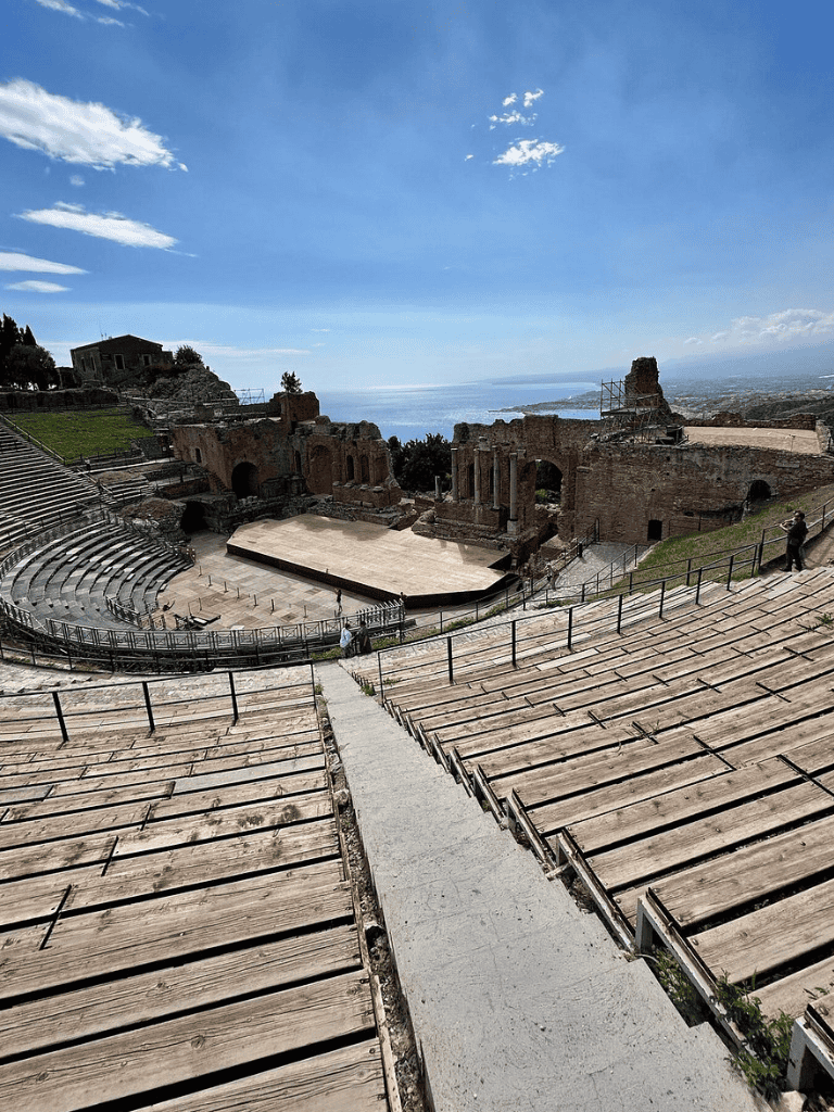 Ancient Greek theater ruins overlooking the coastline, historical site with scenic ocean views.
