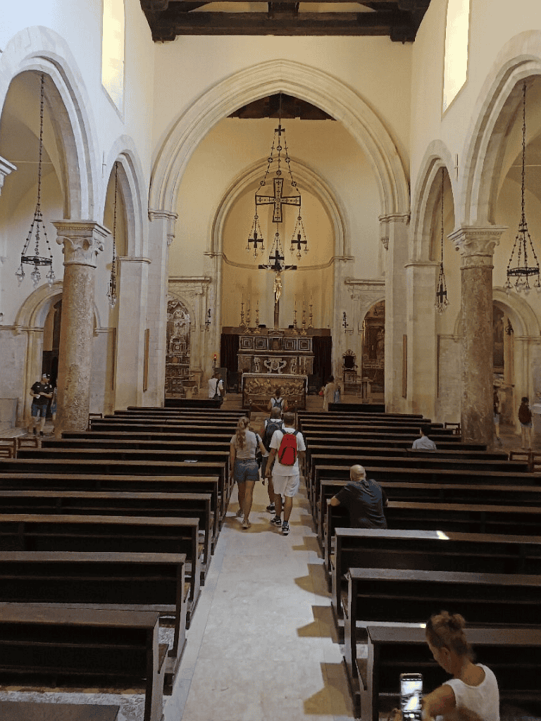 Beautiful church interior with historical architecture and visitors exploring the space.
