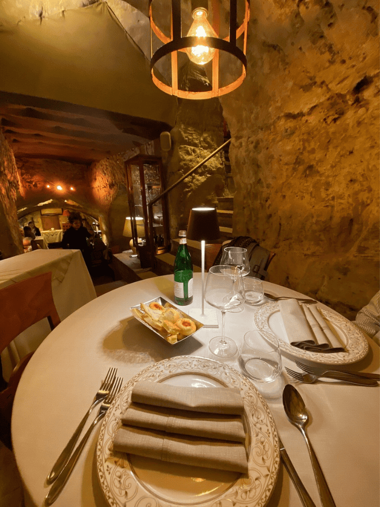 Elegant restaurant table setting with vintage decor and ambient lighting.