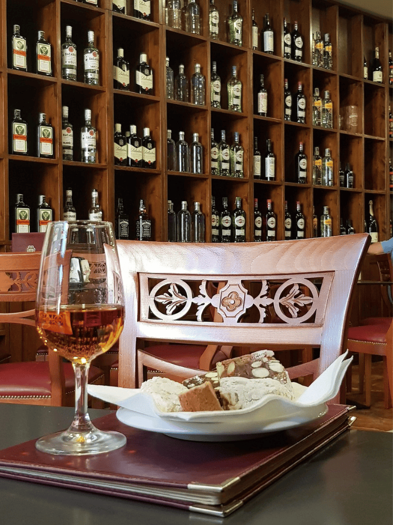 Rich selection of whiskey bottles on wooden shelves at QuestForDirections.