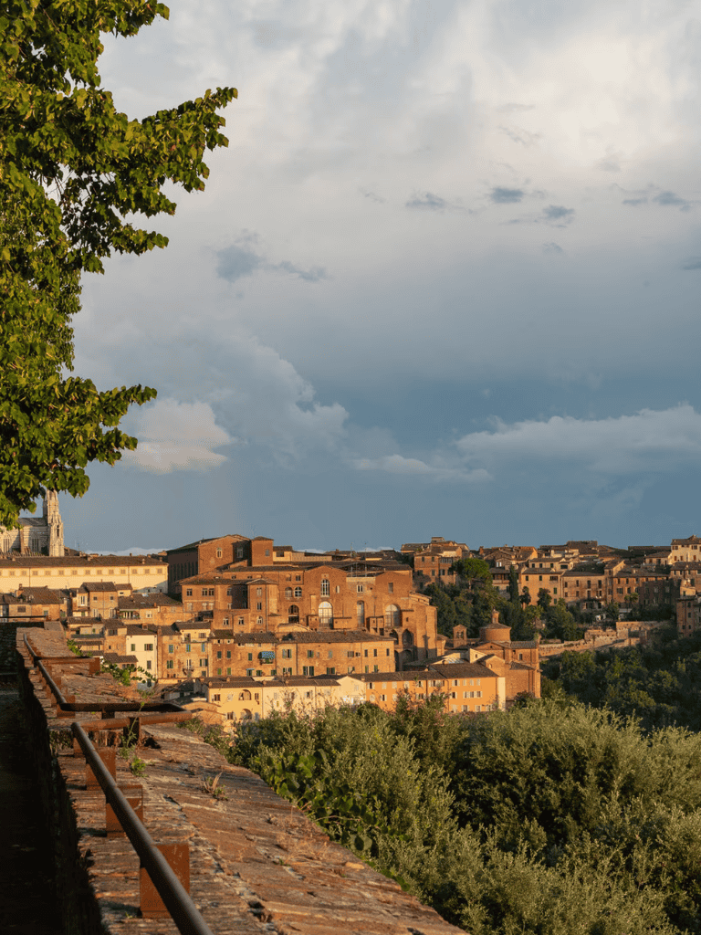 Ancient Italian hillside town with historic architecture and lush greenery, captured in natural daylight.
