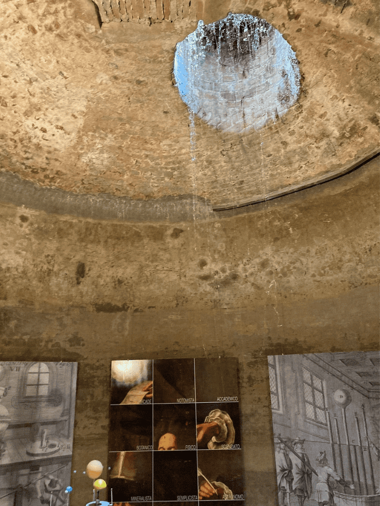 Historical well structure with water dripping from an opening at the top.