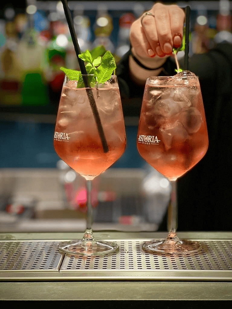 Refreshing pink cocktail with mint garnish at the bar.