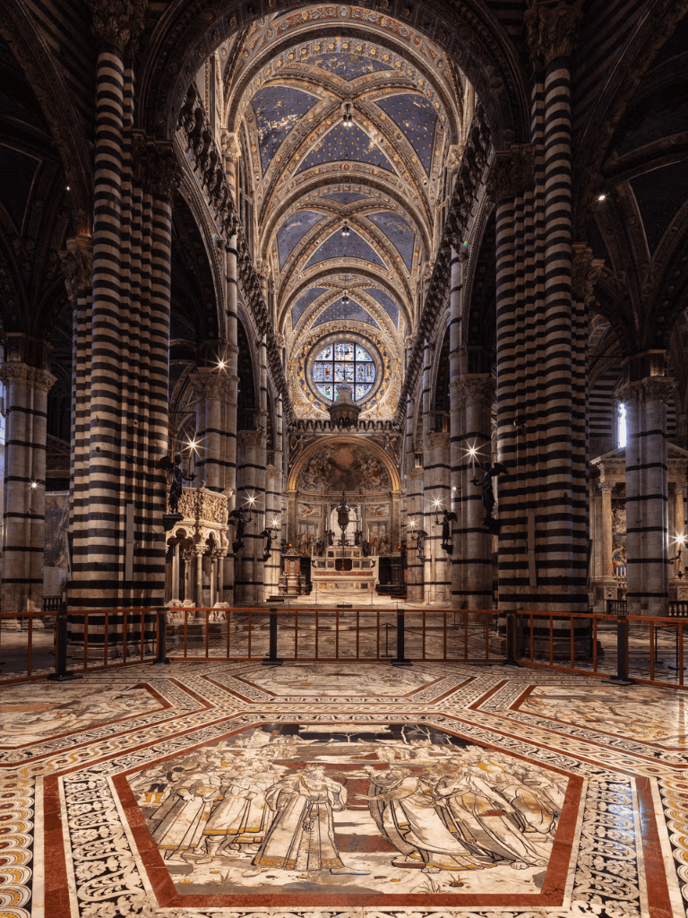 Intricate marble floor and ornate architecture inside Siena Cathedral, Italy.