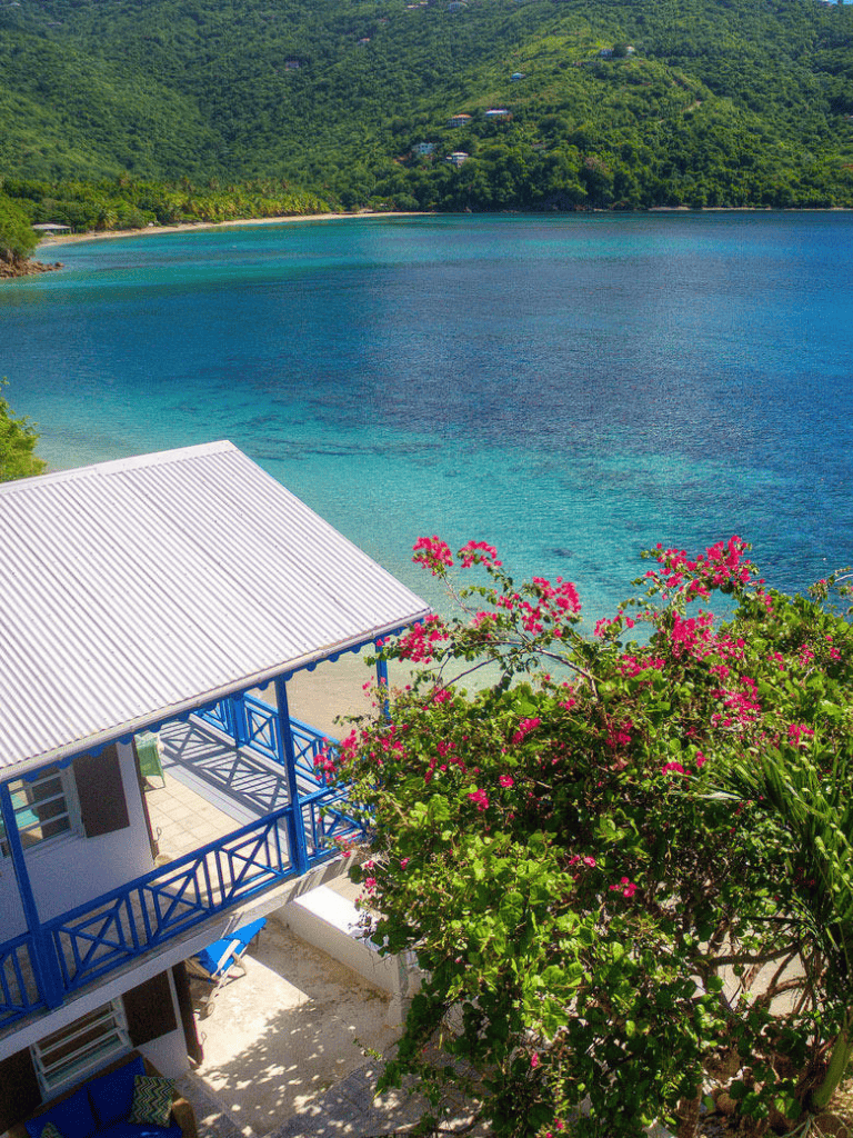 Stunning coastal view with turquoise waters and lush green mountains.