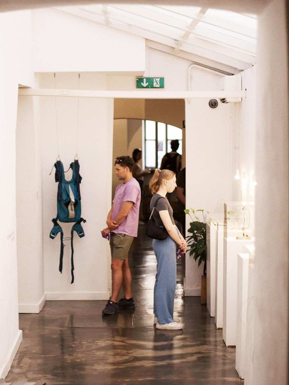 Empty exhibition space at QuestForDirections art gallery showcasing modern design and customer interactions.