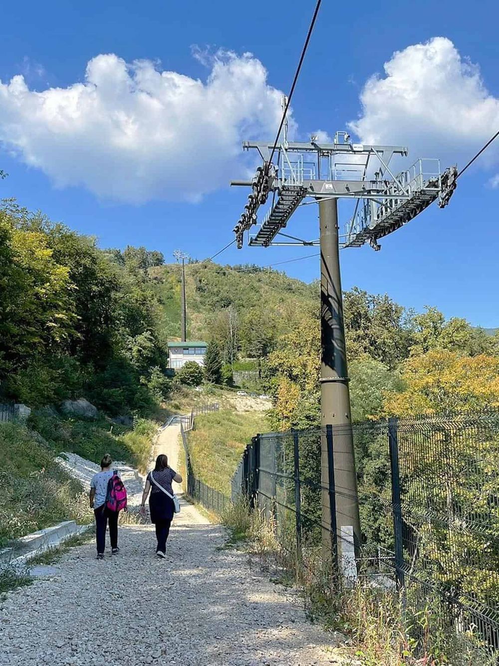 Scenic mountain trail with cable car infrastructure and lush greenery, perfect for outdoor adventures and nature exploration.