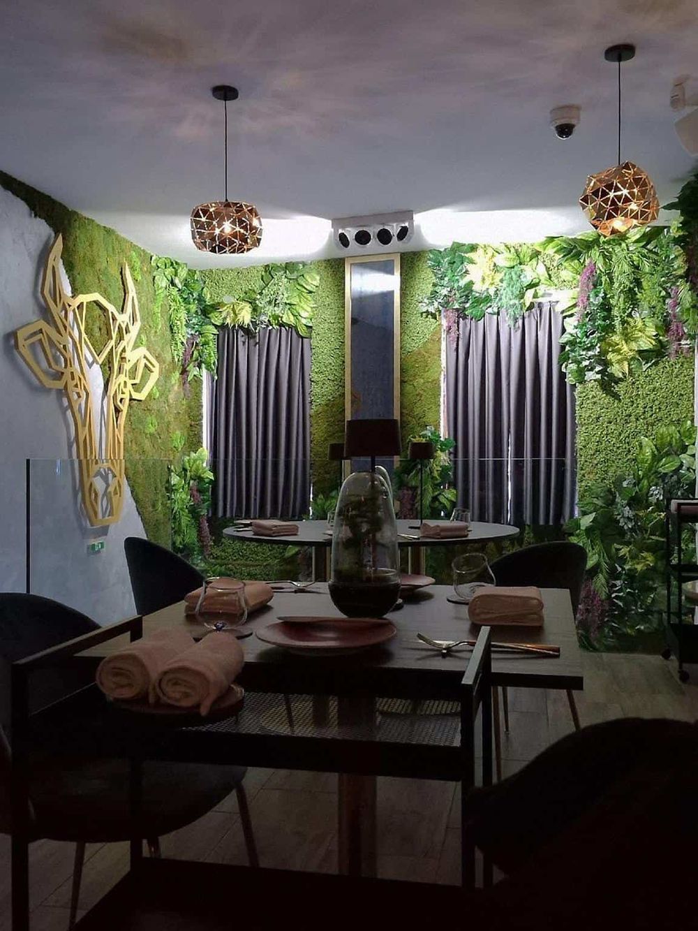 Vibrant indoor restaurant with lush green plant decor and modern lighting, perfect for healthy dining experiences.