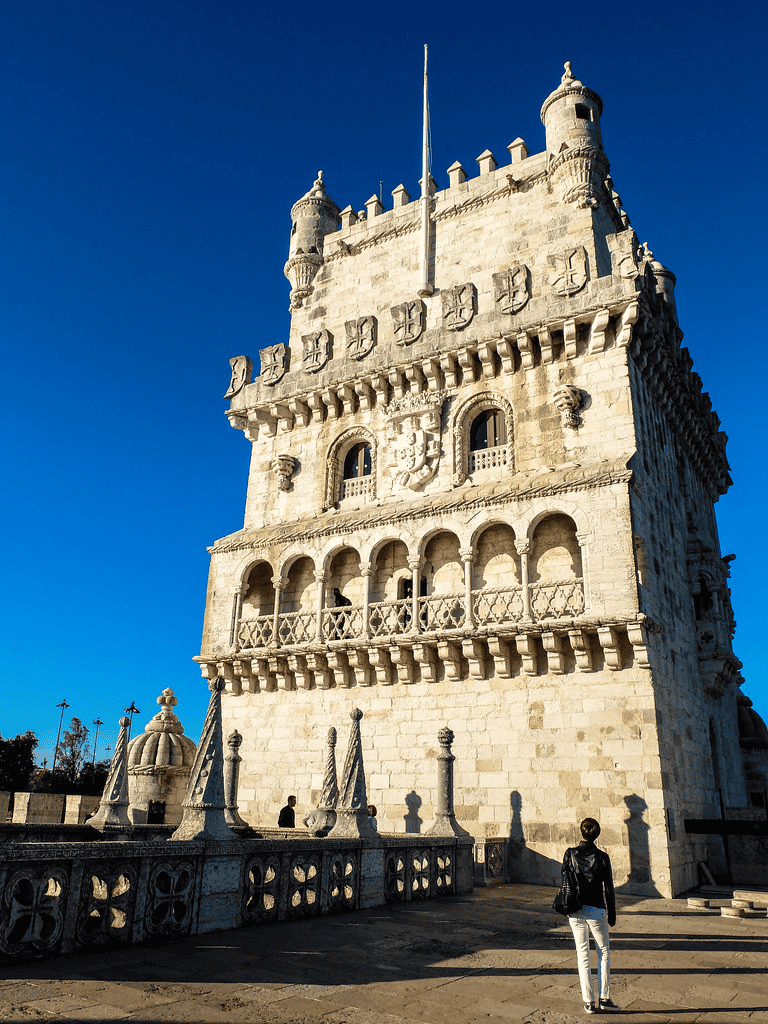 Intriguing historic tower of Belém, Lisbon, Portugal, showcasing ornate architecture and striking blue sky.