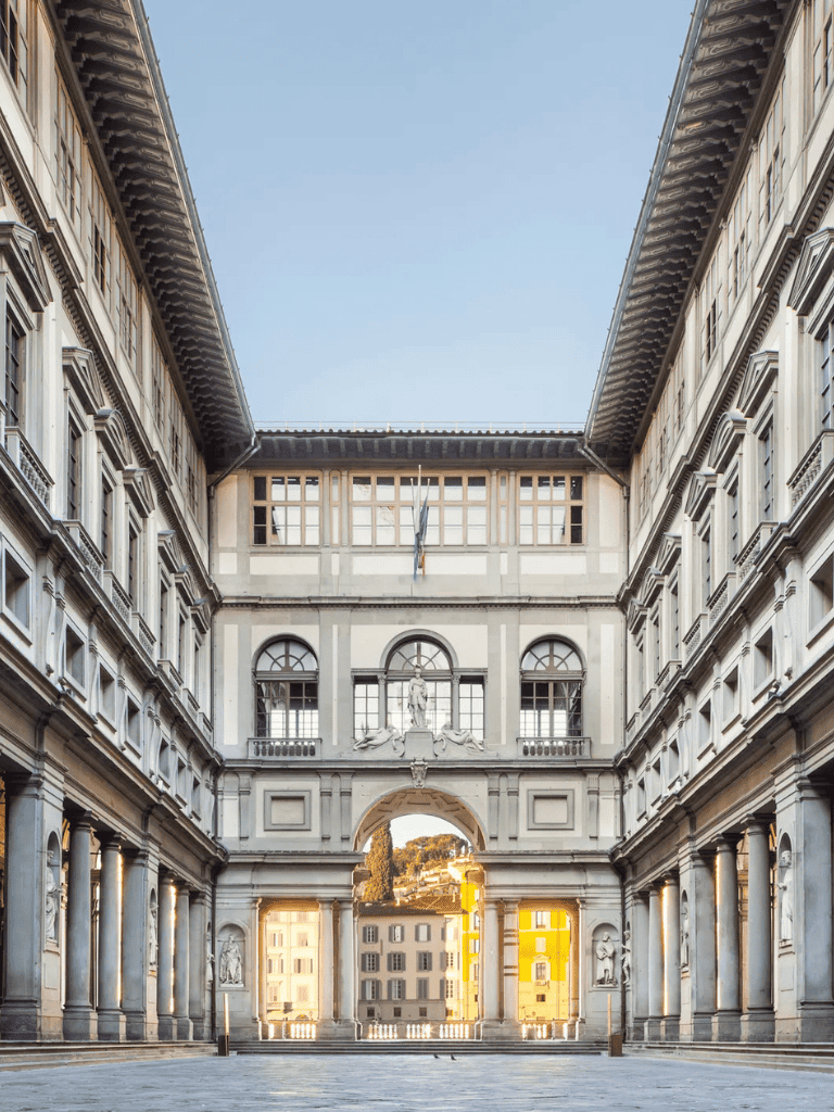 Ancient European courtyard with classical architecture and grand archways, perfect for travel destinations and historical tourism.
