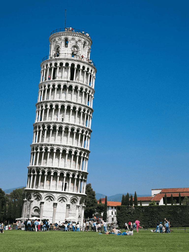 1. Leaning Tower of Pisa with visitors enjoying the landmark in Italy under clear blue sky.