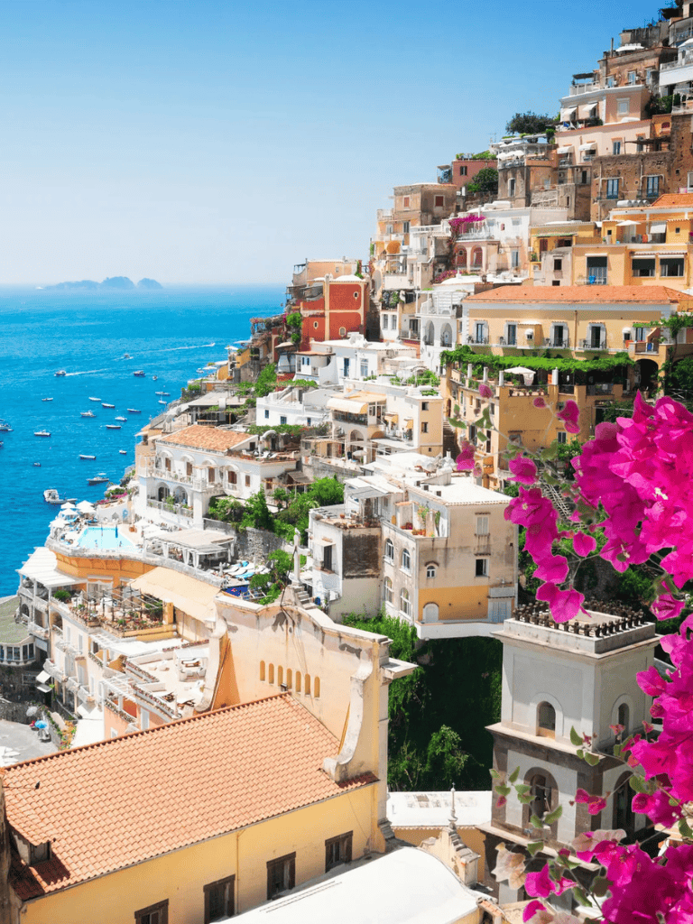 Vibrant coastal town with colorful hillside buildings and seaside view in Italy.