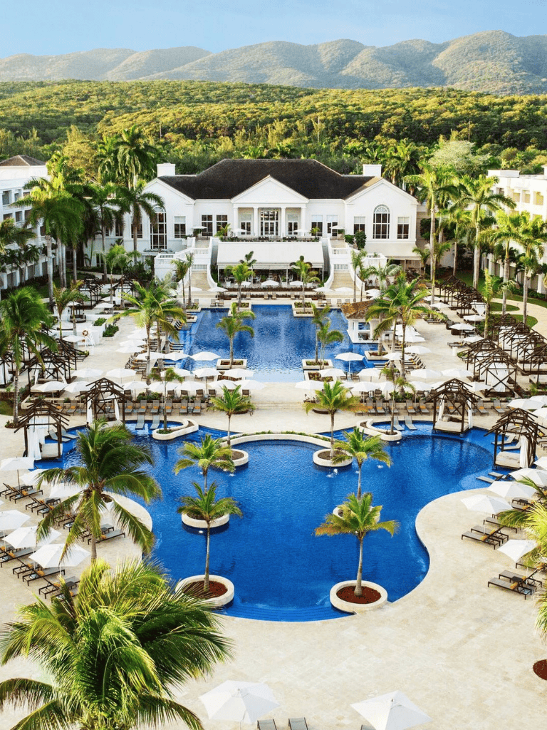 Poolside resort with palm trees and luxurious amenities at QuestForDirections hotel.