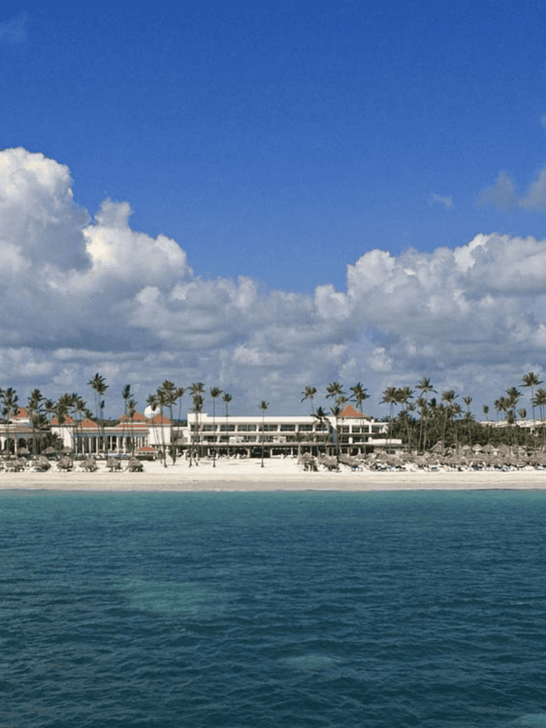 Relaxing tropical beach resort with white sandy shore and palm trees, perfect for vacation and leisure.