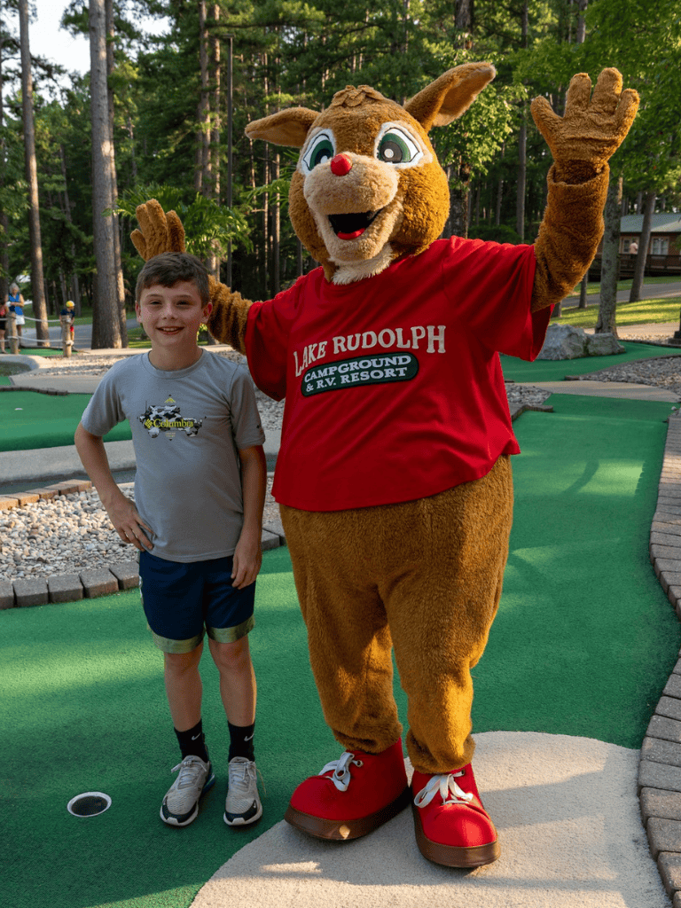 Fun kid with mascot at quest for directions mini golf in palmetto bay florida.