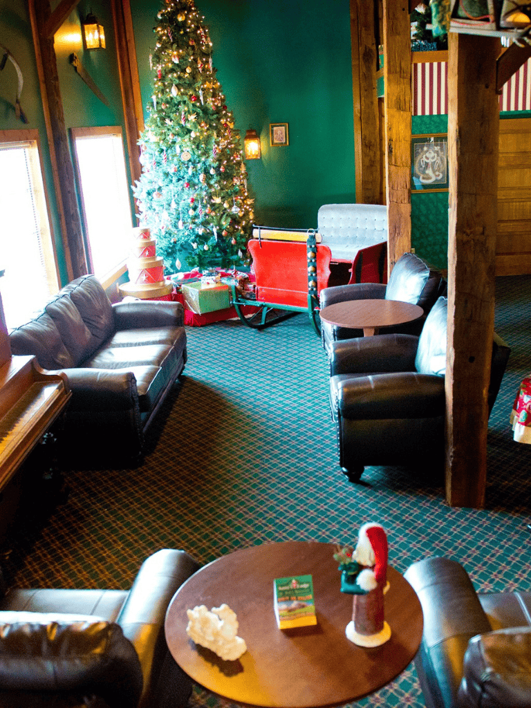 Cozy holiday room with decorated Christmas tree and festive decorations, perfect for holiday celebrations.